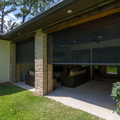 Inspiration for a mid-sized contemporary backyard concrete patio kitchen remodel in New Orleans with a roof extension