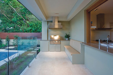 This is an example of a contemporary patio in Sydney with a roof extension and a bbq area.