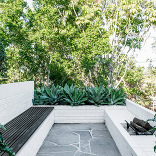 Design ideas for a mid-sized midcentury patio in Brisbane.