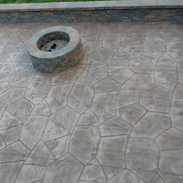 Stamped concrete patio with block seating wall and block fire-pit
