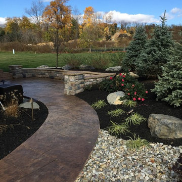 stamped concrete patio with masonry walls and lush plantings