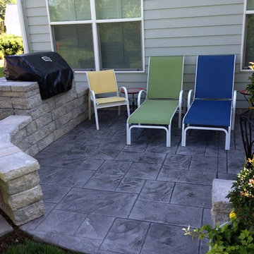 Stamped concrete patio with seating wall and built in grill