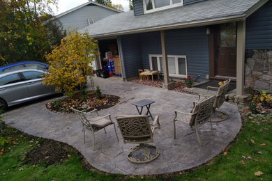 Example of an arts and crafts front yard stamped concrete patio design in Ottawa