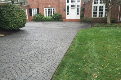 Inspiration for a large modern front yard stamped concrete patio remodel in Indianapolis