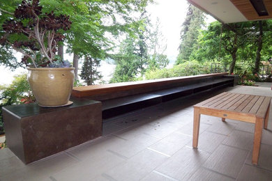 Example of a mid-sized trendy backyard patio design in Seattle with decking and a roof extension