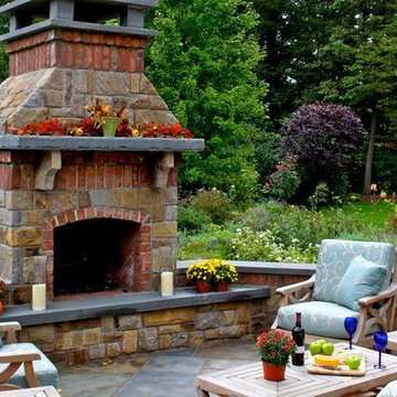 Stone & Brick Fireplace Anchor this Outdoor Livingroom