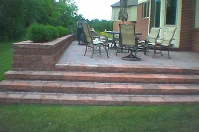 Inspiration for a large contemporary backyard brick patio container garden remodel in Detroit