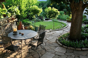 Mid-sized elegant backyard stone patio photo in Charlotte with no cover