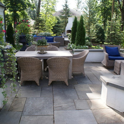 Example of a large classic backyard stone patio design in Minneapolis with no cover
