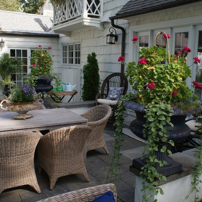 Inspiration for a large timeless backyard stone patio remodel in Minneapolis with no cover