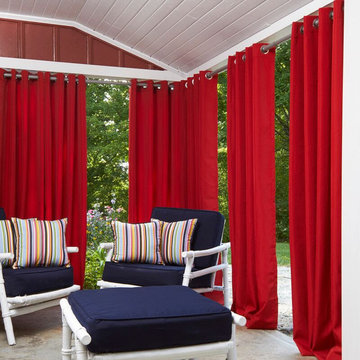 Striking Red Drapes Paired with Blue and Striped Cushions