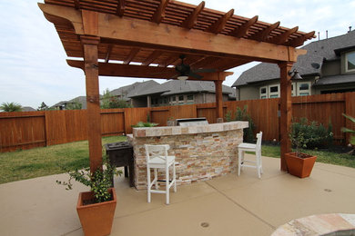 Patio - backyard patio idea in Houston with a pergola