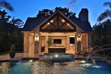 Inspiration for an expansive classic back patio in Houston with an outdoor kitchen, natural stone paving and a gazebo.