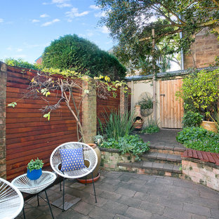 This is an example of a contemporary backyard patio in Sydney with brick pavers and no cover.