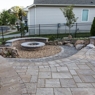 Ispirazione per un patio o portico stile americano di medie dimensioni e dietro casa con un focolare e pavimentazioni in cemento