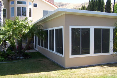Patio - mid-sized traditional backyard concrete patio idea in Orange County with no cover