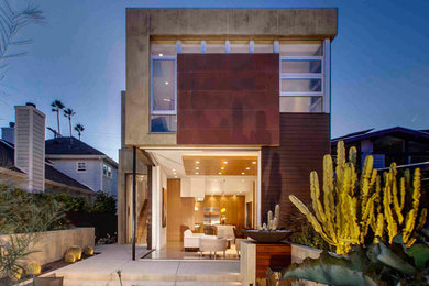 Inspiration for a large contemporary front patio in Los Angeles with a fire feature, concrete slabs and no cover.