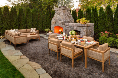 Inspiration for a large timeless backyard stone patio remodel in Portland with a pergola and a fireplace