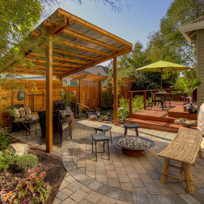 Inspiration for a timeless brick patio remodel in Portland with a fire pit