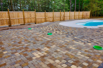 Inspiration for a large modern backyard concrete paver patio remodel in Other with no cover