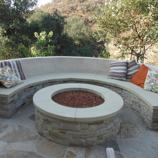 Patio - mid-sized coastal backyard concrete patio idea in Los Angeles with a fire pit