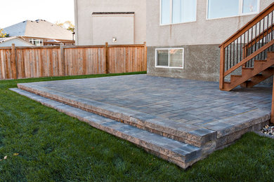 Patio - mid-sized traditional backyard concrete paver patio idea in Other with no cover