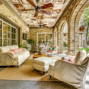 Example of a huge cottage chic backyard stone patio kitchen design in Dallas with a roof extension