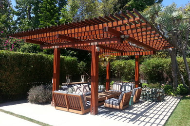 Example of a mid-sized trendy backyard concrete paver patio kitchen design in San Diego with a pergola