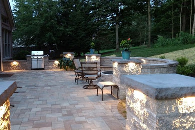 Patio - mid-sized backyard concrete paver patio idea in Other with a fire pit
