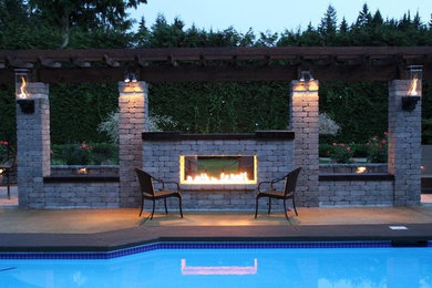 This is an example of a medium sized classic back patio in Sacramento with a fire feature, concrete slabs and a pergola.