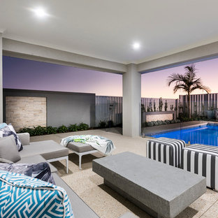 Large contemporary backyard patio in Perth with a roof extension.