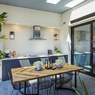 Photo of a contemporary patio in Melbourne with an outdoor kitchen and a roof extension.