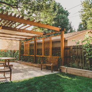 Immagine di un grande patio o portico classico dietro casa con pavimentazioni in cemento e una pergola