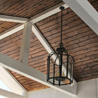 Esempio di un grande patio o portico american style dietro casa con un caminetto, pavimentazioni in cemento e un gazebo o capanno