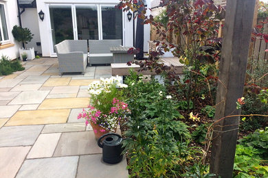 This is an example of a traditional back patio in Devon with natural stone paving.