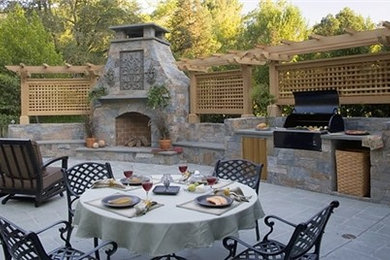 Inspiration for a large mediterranean back patio in San Diego with a fire feature, concrete paving and no cover.