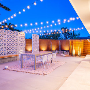 Inspiration for a mid-sized southwestern backyard concrete patio remodel in Other with no cover and a fire pit