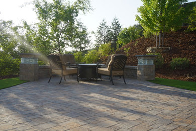 Mid-sized transitional backyard concrete paver patio photo in Sacramento with no cover