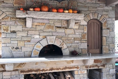 Patio kitchen - mid-sized rustic backyard stone patio kitchen idea in Portland with a gazebo