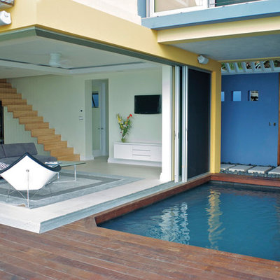 Inspiration for a contemporary patio remodel in Miami with decking and no cover