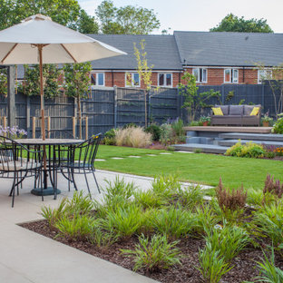 Inspiration for a contemporary back patio in Hampshire with concrete slabs and a pergola.