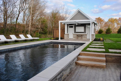 Inspiration for a large contemporary backyard stone patio remodel in Indianapolis with a pergola