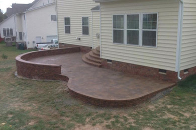 Example of a mid-sized classic backyard brick patio design in Richmond with no cover