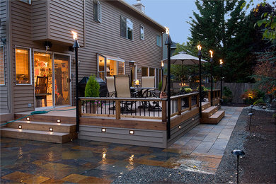 Classic back patio in Seattle with no cover and decking.