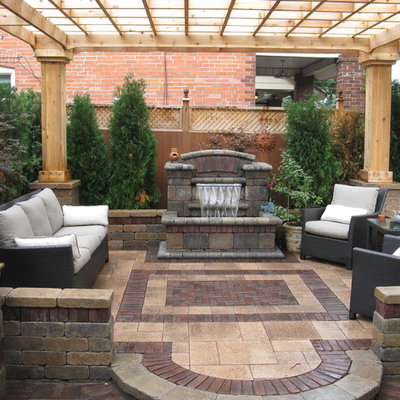 Inspiration for a contemporary patio fountain remodel in Other with a pergola