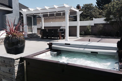 Inspiration for a large modern backyard concrete paver patio remodel in Los Angeles with a pergola