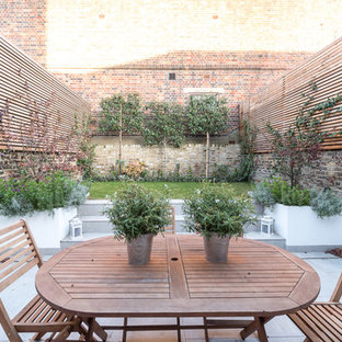 This is an example of a medium sized traditional back patio in London.