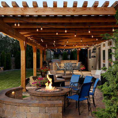 Patio - mid-sized rustic backyard stamped concrete patio idea in Boise with a pergola