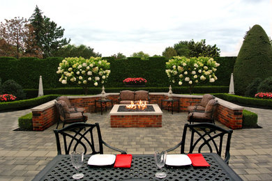 Large trendy backyard stone patio photo in Detroit with a fire pit and no cover
