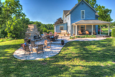 Patio - large traditional backyard concrete paver patio idea in Kansas City with a fire pit and no cover